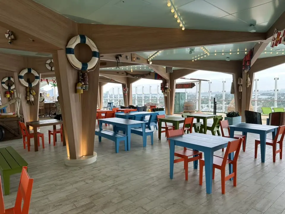 Basecamp restaurant aboard Icon class cruise ship, vibrant ocean-view dining as part of your dream cruise vacation.