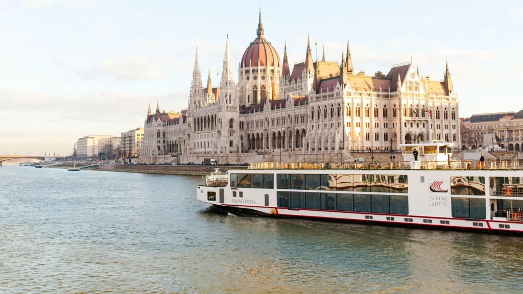 Viking River Cruise Eistla passing the Hungarian parliament building in Budapest representing stunning views and the historical value that comes naturally with river cruises.